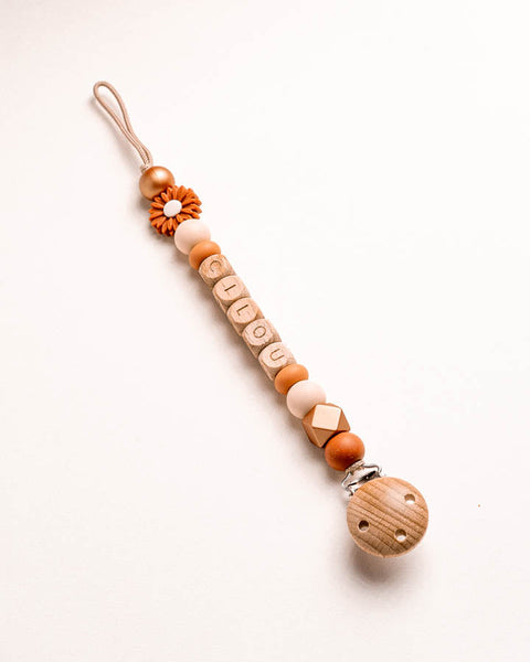 gepersonaliseerd speenkoordje met naam en houten letterkralen met de naam cilou